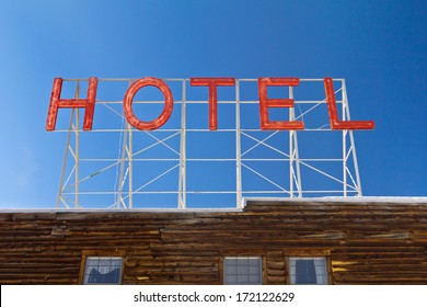 Vintage Hotel Sign Above An Old Wooden Cabin In The Colorado Rocky Mountains