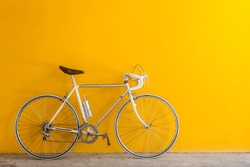 The Vintage  Hybrid Bicycle Parking Against Yellow Wall