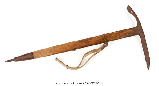 Vintage ice axe with wooden handle and rusty steel head and spike made in 66 of the last century, production date stamped on pick, lies on a white background, view profile