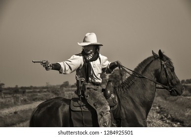 Vintage image of cowboy Showing horse riding, and shooting guns