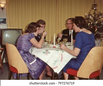 Vintage 1950´s image: family enjoying the Christmas holidays with a dinner. 