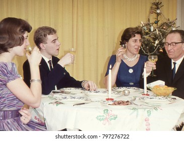 Vintage 1950´s Image: Family Enjoying The Christmas Holidays With A Dinner And Wine. 