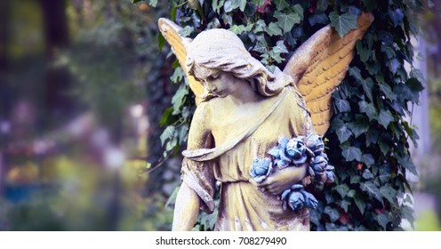 Vintage image of a sad angel against the background of leaves (fragment) - Powered by Shutterstock
