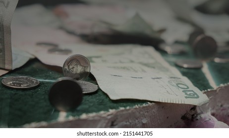 Vintage image of scattered silver coins with banknotes