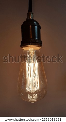 Vintage incandescent lamp. Old incandescent light bulb on a dark background. Vintage item