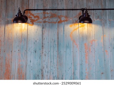 Vintage industrial lamps illuminating a rustic wooden wall in soft light, creating a warm and inviting atmosphere. - Powered by Shutterstock