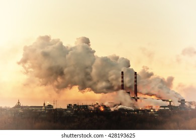 Vintage Industrial Landscape With Chemical Factory, Pipes And Smoke, Long Exposure