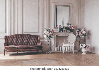 Vintage Interior Sofa With A Vase Of Flowers In Shabby Chic Style.