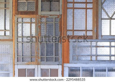 Vintage interior Wall background made of many the old Wooden windows Reused with Patterned Glass