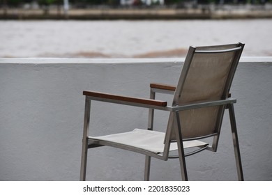 Vintage Iron Or Metal Chair On River Background,outdoor Seating For A Morning Coffee Beside River.selective Focus.