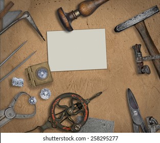 vintage jeweler tools and diamonds over  working bench, blank business card for your text