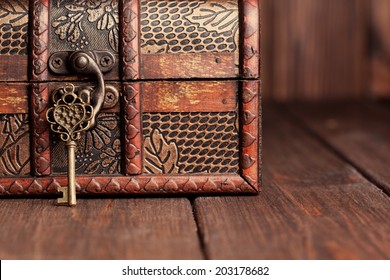 vintage key and old treasure chest on wooden table