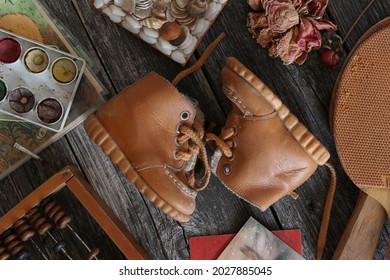 Vintage Kids Yellow Leather Shoes And Dried Paint,tennis Rackets,homemade Jewelry Box And Dried Peony Flowers.View From Above.