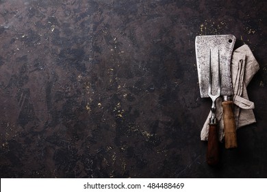 Vintage Kitchenware Kitchen Utensils Meat Fork And Butcher Cleaver On Dark Background