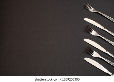 vintage knives and forks on a black background
