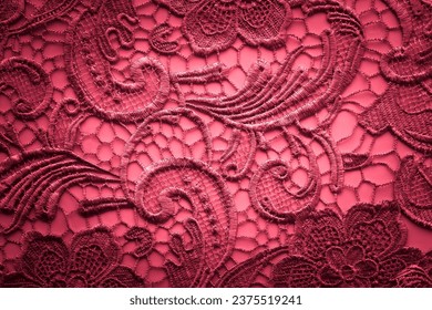 Vintage lace fabric with floral pattern, red background with lace pattern.