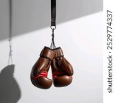 Vintage Leather Boxing Gloves Hanging on White Background
