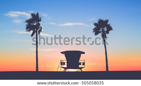 Vintage Lifeguard Tower at the Beach with sunset in background in San Diego, California 
