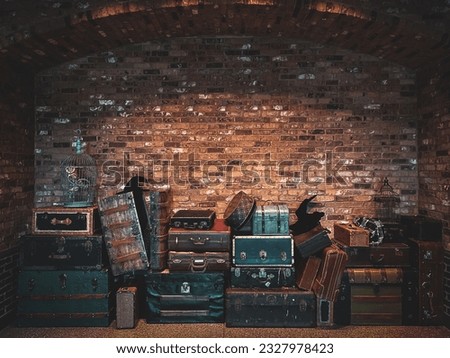Vintage luggage, owl in cage, witch hat, and brick background. Wizard theme. Room for text. Grungy texture. 
