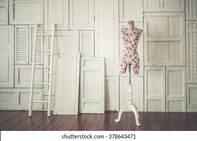 Vintage mannequin in cozy designer studio with ladder against the white wall and wooden laminate floor, art color filter applied  - Powered by Shutterstock