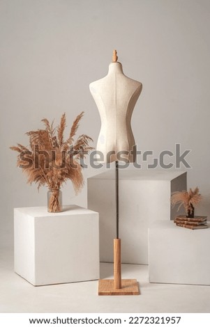Vintage mannequin without hands on a light studio background