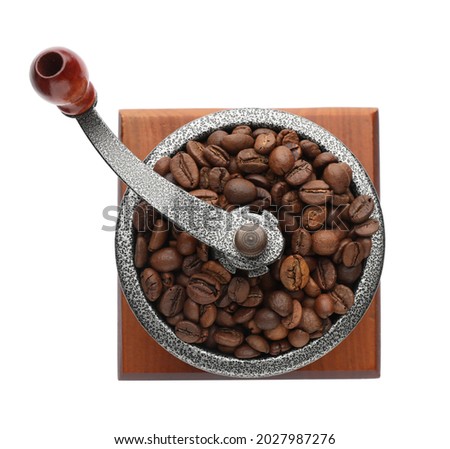 Vintage manual coffee grinder with beans isolated on white, top view
