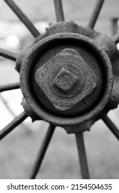 Vintage mechanical metal farm wagon wheel in black and white.