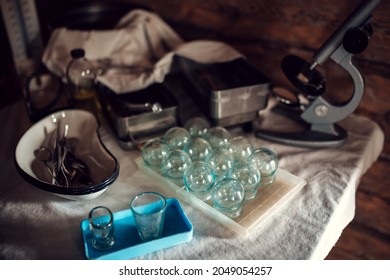 Vintage Medical Instruments On The Table - Vacuum Glass Jars, Microscope, Doctor Workplace