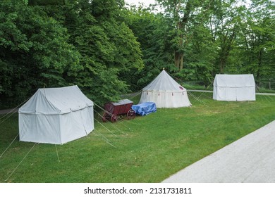 Vintage Medieval Wagons With Food And Tents On The Background Of The Forest. Medieval Bivouac Of Troops. Tents At The Outskirts Of The Castle