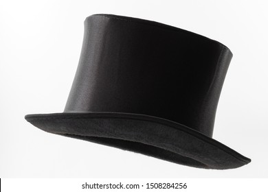 Vintage men fashion and magic show conceptual idea with side profile angle on victorian black top hat with clipping path cutout in ghost mannequin technique isolated on white background