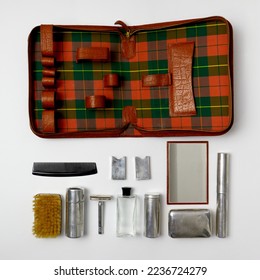 Vintage men's grooming and travel kit with shaving tools, toothbrush holder, soap box, razor box, brown leather case, chrome plated, made in 1950s. - Powered by Shutterstock