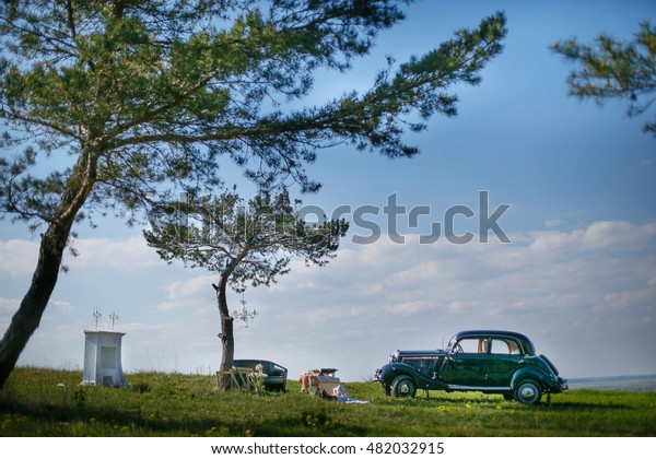 Vintage\
Mercedes, old couch and trees somewhere\
afield