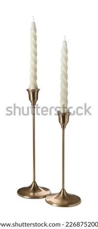 Vintage metal candlesticks with candles on white background