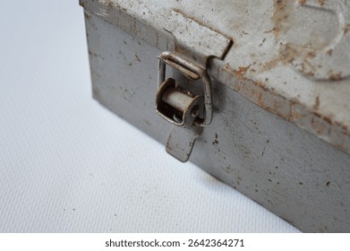 Vintage metal toolbox with rusty patina and embossed wrench design. Ideal for themes of repair, DIY, mechanics, handyman work, retro tools, and industrial style.