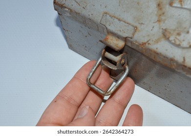 Vintage metal toolbox with rusty patina and embossed wrench design. Ideal for themes of repair, DIY, mechanics, handyman work, retro tools, and industrial style.