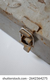 Vintage metal toolbox with rusty patina and embossed wrench design. Ideal for themes of repair, DIY, mechanics, handyman work, retro tools, and industrial style.