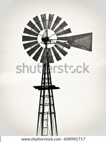 Vintage metal windmill against white background
