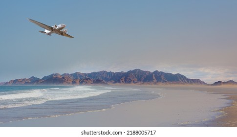 Vintage metallic propeller airplane in the sky, sunset clouds in the background - Namib desert with Atlantic ocean meets near Skeleton coast - 
Namibia, South Africa