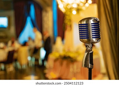 Vintage microphone on stage at a wedding reception venue. A vintage microphone stands ready as guests enjoy a wedding reception. - Powered by Shutterstock