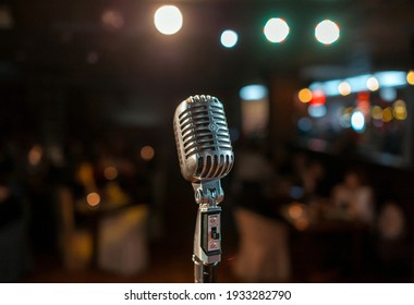 Vintage Microphone On A Stand Standing On A Lighted Stage. View Of The Auditorium From The Stage. Microphone On A Lighted Stage. Karaoke.