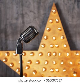 Vintage Microphone In Studio With Star On Background
