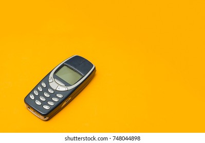 vintage mobile phone with copyspace on yellow background