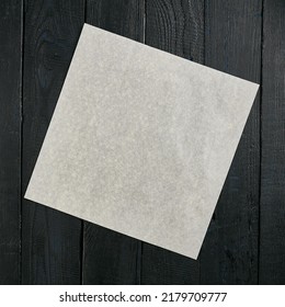 Vintage mock up with blank parchment on a black wooden background. Dark wooden background with copy space. Black wood with a piece of paper for design. Dark wooden background. - Shutterstock ID 2179709777