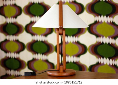A vintage modern desk lamp from the 60s made out of tak wood standing on a desk isolated on white background very rare in original condition design icon close up living room minimalistic danish design