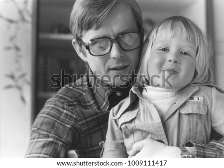 Vintage monochrome 1970´s portrait of happy father and daughter.