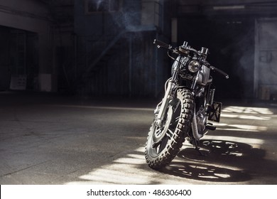 Vintage Motorcycle Standing In A Dark Building In The Rays Of Sunlight. Toned Colors. Front View