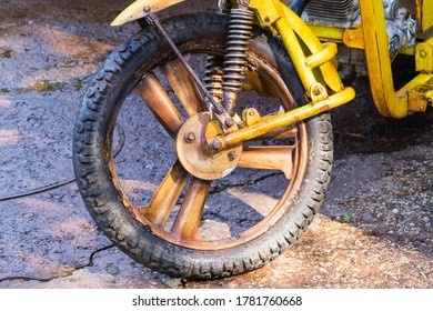 Vintage Motorcycle Wheel On Wet Pavement