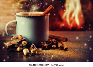 Vintage mug of hot chocolate with cinnamon sticks over dark background. - Powered by Shutterstock