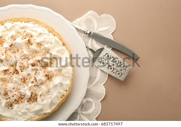 Vintage napkin and plate with delicious\
coconut cream pie on light\
background