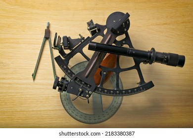 Vintage Nautical Sextant With Protractor And Dividers Set On Navigation Chart Table. Top Down View